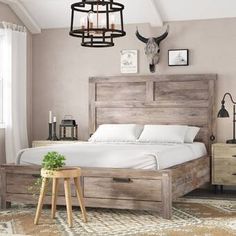 a bed sitting in a bedroom next to a wooden dresser and table with a potted plant on it