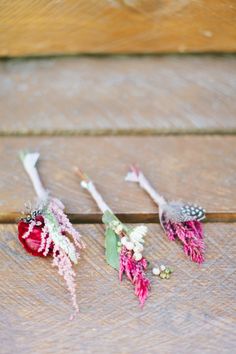 three flowers are sitting on the ground next to each other, one is pink and white