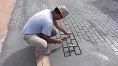 a man kneeling down on top of a cement slab