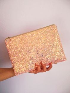 "Bubblegum Pink Glitter Clutch Bag. This sparkly bubblegum pink clutch bag is made out of a glitter covered cotton and would be the perfect accessory for a spring wedding, festival and parties. This light pink has a shimmer of iridescent glitter that catches the light. This bag comes with a beige YKK zip with gold teeth and measures about 10\" x 7\". These would make really pretty gifts and add some sparkle to any wardrobe. They're big enough to fit your everyday essentials in such as a mini iPa Pink Clutch Bag, Glitter Clutch Bag, Rainbow Sunglasses, Clutch Pink, Glitter Clutch, Velvet Purse, Gold Teeth, Pink Clutch, Wedding Bag