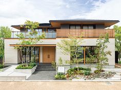 a modern house with lots of windows and plants