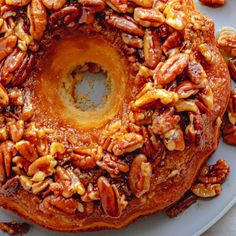 a bundt cake with pecans and nuts on top