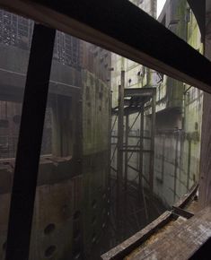 an old factory building is seen through the window in this view looking down at it