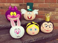 several decorative pumpkins with faces painted on them