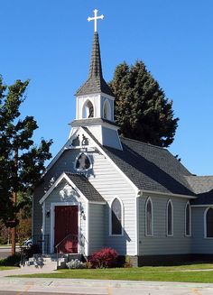 a church with a steeple and a cross on top