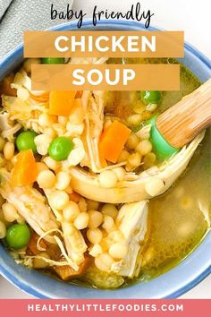 a bowl of chicken soup with peas, carrots and corn is shown in this image