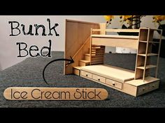 a wooden bunk bed with drawers and shelves next to a sign that says popsicle stick