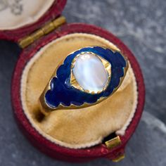 This ethereal ring is centered with an oval gem-quality moonstone cabochon. The moonstone glows atop the dark blue enamel accented shoulders. The ring has a Swiss "Three Crown" stamp. It is crafted in 18K yellow gold and is now and forever a size 9. Please note that there is some jeweler's epoxy exposed from setting the moonstone. Due to the enamel details of this ring, we are not offering resizing on this piece. Antique Engagement Rings Sapphire, Audry Rose, Cabin Door, Estate Jewelry Rings, Moonstone Cabochon, Diamond Dangle Earrings, Pretty Clothes, Antique Engagement Rings, Cabochon Pendant