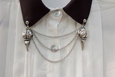 Bird skull collar chain to liven up your shirt collars. Attaches with a pin at the top of each skull charm. Skull charms are about 1.5 inches long and the top chain is approximately 3.5 inches long, allowing for a clean drape across your collar. If you need a different chain length, just leave it in a note with your order. Let me know if you have any questions. Skull Collar, Collar Clips, Silver Bird, Sweater Clip, Collar Chain, Collar Pins, Bird Skull, Estilo Punk, Iowa