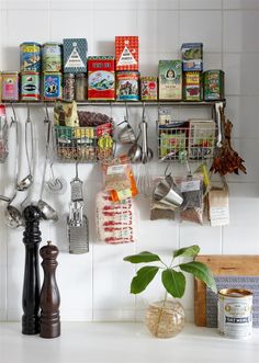 a kitchen counter with pots, pans and utensils hanging on the wall