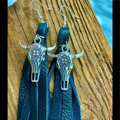 Black Leather Fringe, Skull Earrings. Cattle/ Buffalo Cowgirl Boho Chic Earrings. Compliments Will Be Lassoed Your Way Girls. These Sell Out Quickly In Our Boutique. . Wrangler Roper Jeans Outfits Boots Perfect Boho Music Festival Or Summer Rodeo . Look In My Closet For More Genuine Leather Earrings , Handmade Here In The Foothills Of Nc Made In The Usa #Westernboutique #Cowearrings Elegant Black Concho Jewelry, Adjustable Concho Earrings For Festival, Black Fringe Jewelry For Festival, Black Tassel Jewelry For Festival, Black Tassel Earrings As Gift, Black Tassel Earrings For Gift, Black Tassel Earrings For Festival, Black Dangle Tassel Earrings For Festival, Adjustable Leather Tassel Earrings