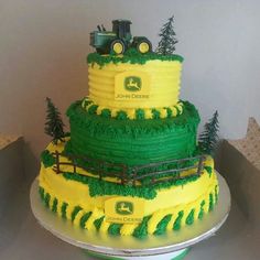 there is a large cake with green and yellow frosting on the top that says john deere