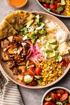 a plate with chicken, rice, corn, tomatoes and avocado on it