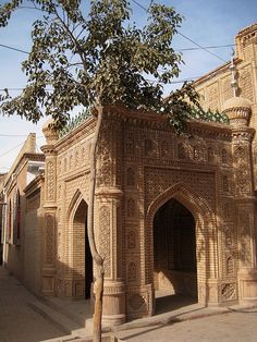 an old building with a tree growing out of it