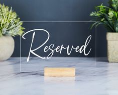 a clear acrylic sign that reads reserved