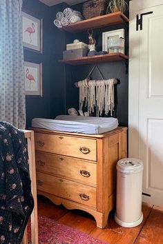 a baby's crib in the corner of a room next to a dresser