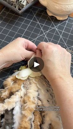 a person is cutting up an animal's fur on a table with other items