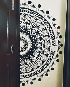 a black and white drawing on the side of a refrigerator freezer next to a door