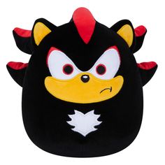 a black and yellow stuffed animal with red horns on it's head is shown