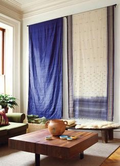 a living room with two couches and a coffee table in front of the window