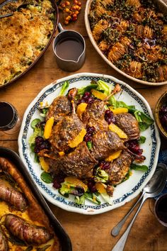 a table topped with lots of different types of food and dishes on top of it