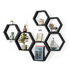 the hexagonal shelves have various items on them