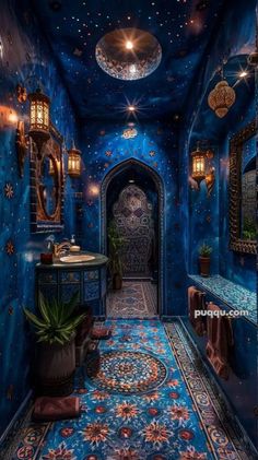 an ornate hallway with blue walls and flooring is lit up by hanging lights from the ceiling