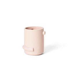 a small pink cup with a handle on the top and bottom, sitting in front of a white background