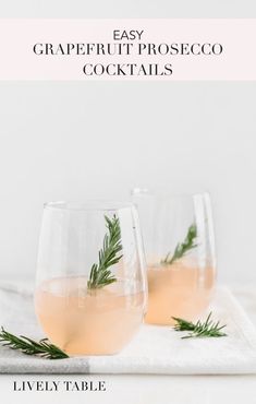 two wine glasses filled with grapefruit proseco cocktails on a white towel