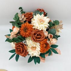 a bridal bouquet with orange and white flowers