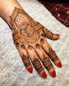 a woman's hand with henna tattoos on it