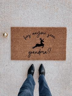 a person standing in front of a door mat that says why anyone sees grandpaa?