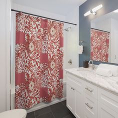 a bathroom with red and white shower curtain