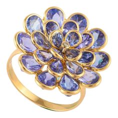 This is part of Chairish’s Fine Jewelry assortment.  Tanzanite flower ring in 18k gold which perfectly goes with your personality. This gorgeous ring is a perfect bridesmaid, wedding gift for anyone on your list. Tanzanite facilitate a higher consciousness and stimulate intuition and perception Designed with cluster of pear cut tanzanite with a diamond in center that makes it a perfect fit to wear it on your wedding or style it with any of your basic outfit to give it a glam.   PRODUCT DETAILS : Flower Diamond Ring, Gold For Sale, Gorgeous Ring, Gold Gemstone Ring, Higher Consciousness, Tanzanite Gemstone, Ring With Diamond, Bridesmaid Wedding, Pear Diamond