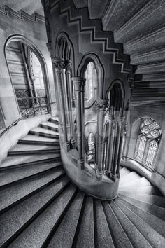 an image of a spiral staircase in the middle of a building with windows and doors