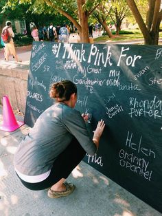 a man writing on a blackboard with chalk