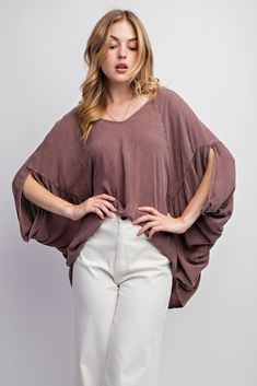 Easel's Mineral Washed Gauze Loose Fit Top features batwing/dolman sleeves, v-neckline and a boxy and oversized silhouette for a stylish, relaxed look. The soft and lightweight mineral washed gauze material adds breathability and comfort. Material and Care 100% Rayon Hand Wash Cold Hang to Dry Measurements Small Bust:38" Length: 27 ” Sleeve Length:20” Medium Bust:40” Length:28 ” Sleeve Length:21” Large Bust:42 ” Length:29 ” Sleeve Length:22” Trendy Oversized V-neck Blouse, Casual Tops With Kimono Sleeves For Fall, Casual Fall Tops With Kimono Sleeves, Oversized V-neck Poncho For Spring, Casual Billowy V-neck Tops, Oversized Short Sleeve Poncho, Oversized Batwing Sleeve Poncho For Spring, Billowy V-neck Tops For Fall, Oversized Casual Poncho With Batwing Sleeves