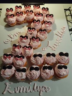 there are many cupcakes with pink frosting in the shape of mickey ears