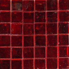 a close up shot of red glass tiles