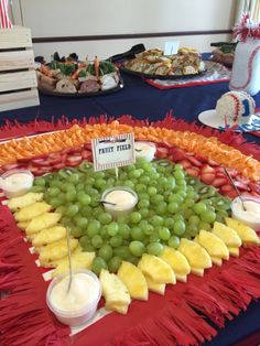 a platter with fruit and dips on it