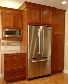 a kitchen with wooden cabinets and stainless steel appliances