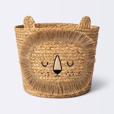 a small basket with a bear face on the front and sides, made out of straw