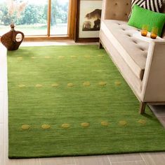 a living room with a couch and green rug