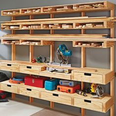 a workbench with lots of drawers and tools on the shelves in front of it