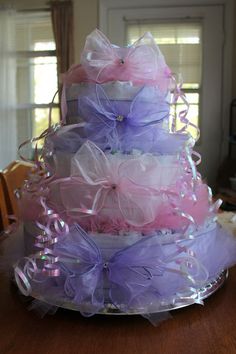 a multi layer cake sitting on top of a wooden table