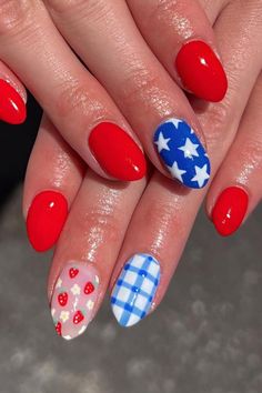 These almond-shaped nails are a vibrant celebration of color and pattern. The glossy red polish makes a bold statement, complemented by a nail with a crisp blue base featuring white stars, and another showcasing a charming gingham pattern in sky blue and white. Accentuating the mix is a delightful nail with a sweet strawberry and flower design on a sheer backdrop. A perfect way to add a pop of patriotism and summer fun to any look! 🍓🌸🇺🇸  // Photo Credit: Instagram @mynailgirlness 4th Of July Nail Designs, July Nail Designs, Blue Stiletto Nails, 4th Of July Nail, Oval Shaped Nails, Nails Healthy, Patriotic Nails, Festive Nail Designs, Western Nails