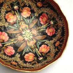 a decorative bowl with flowers painted on it