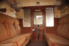 the inside of an old train car with three seats and two windows on each side