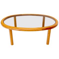 an oval glass table with wooden legs