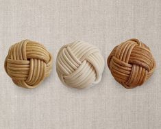 three different types of knoted buttons on a white surface with the words natural light dark oak